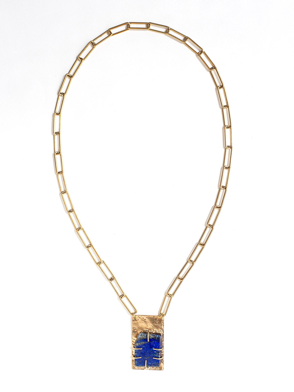 A brass chain link necklace with lapis lazuli and brass pendant handcrafted by Canadian jewelry designer Michelle Ross
