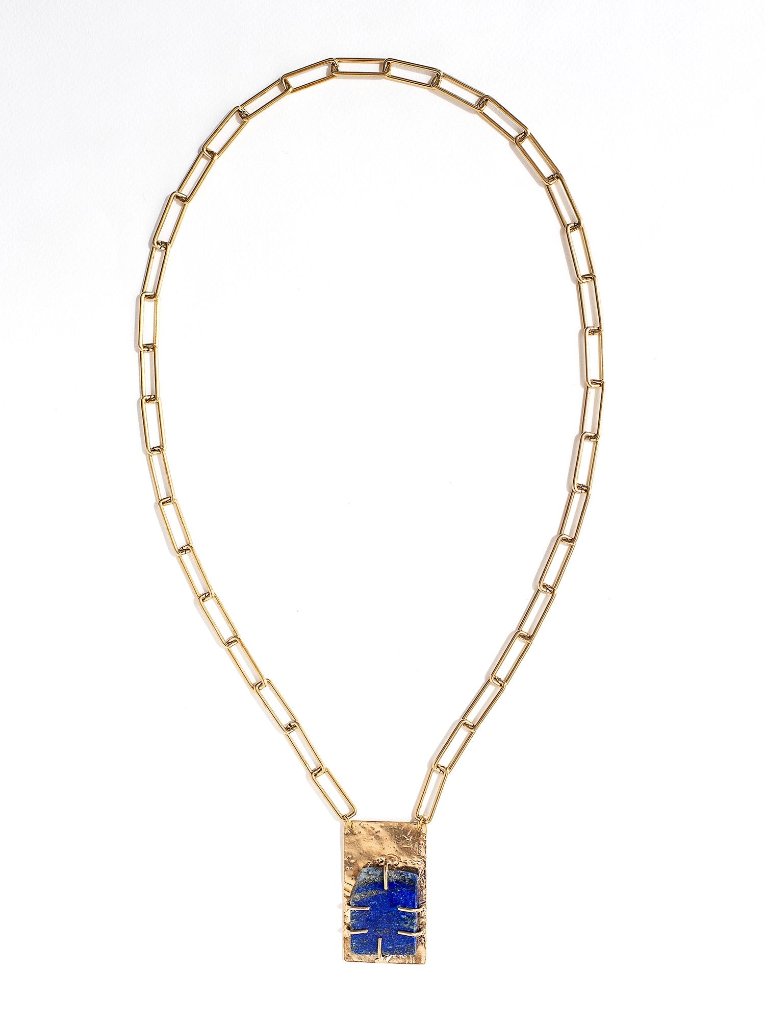 A brass chain link necklace with lapis lazuli and brass pendant handcrafted by Canadian jewelry designer Michelle Ross