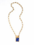 A brass chain link necklace with lapis lazuli and brass pendant handcrafted by Canadian jewelry designer Michelle Ross