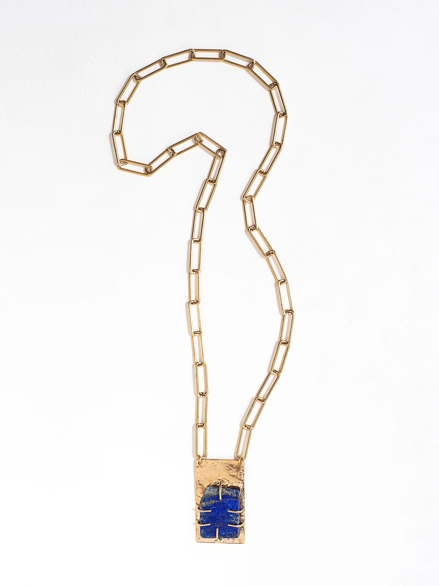 A brass chain link necklace with lapis lazuli and brass pendant handcrafted by Canadian jewelry designer Michelle Ross