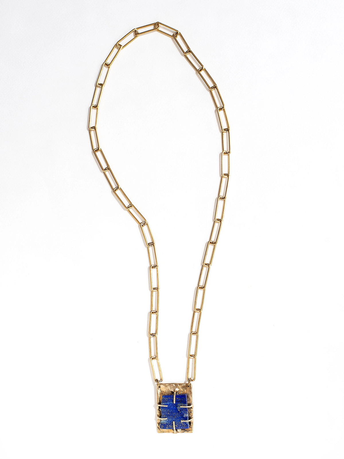 A brass chain link necklace with lapis lazuli and brass pendant handcrafted by Canadian jewelry designer Michelle Ross
