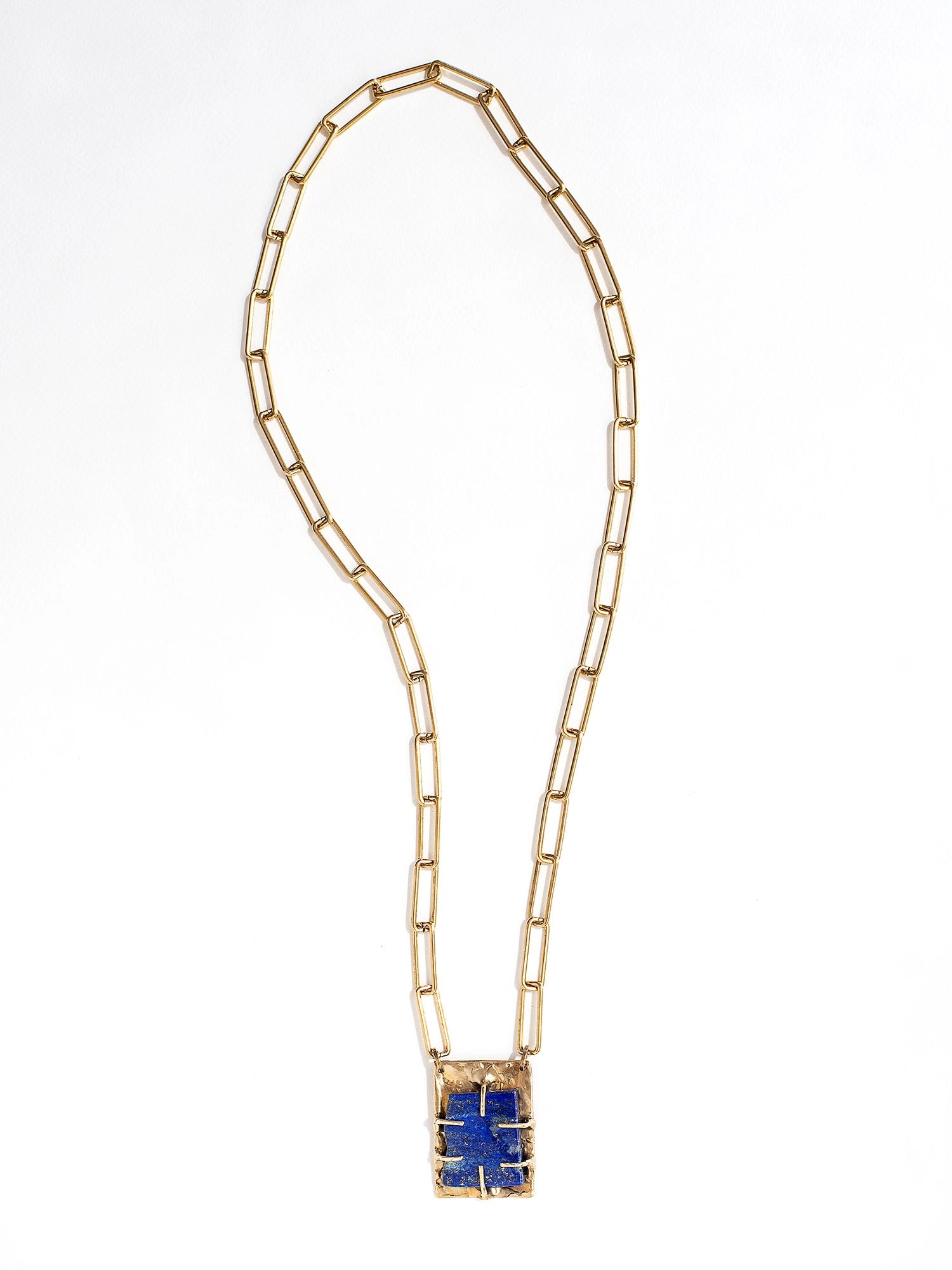 A brass chain link necklace with lapis lazuli and brass pendant handcrafted by Canadian jewelry designer Michelle Ross