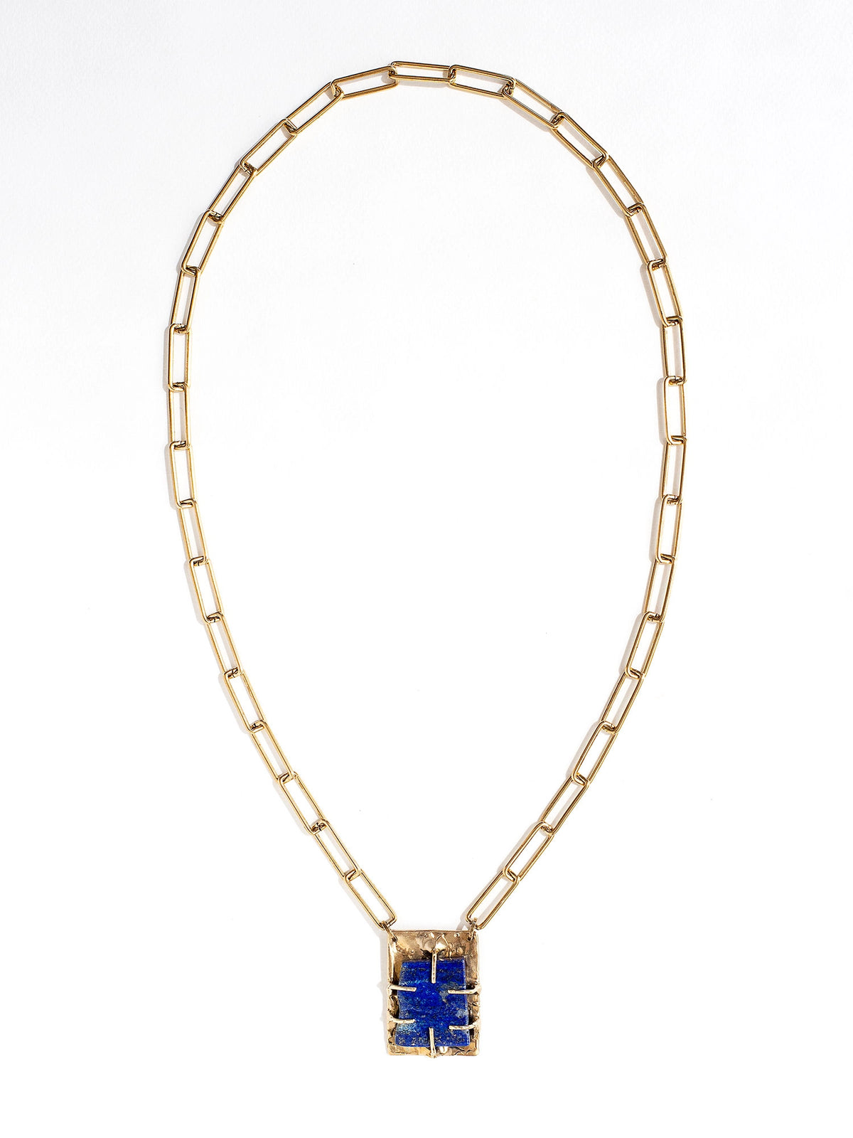 A brass chain link necklace with lapis lazuli and brass pendant handcrafted by Canadian jewelry designer Michelle Ross