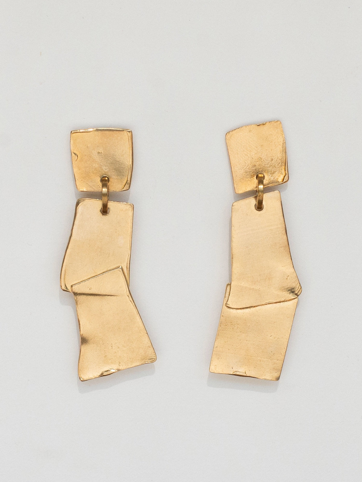 A pair of geometric brass statement earrings by Toronto Designer Michelle Ross
