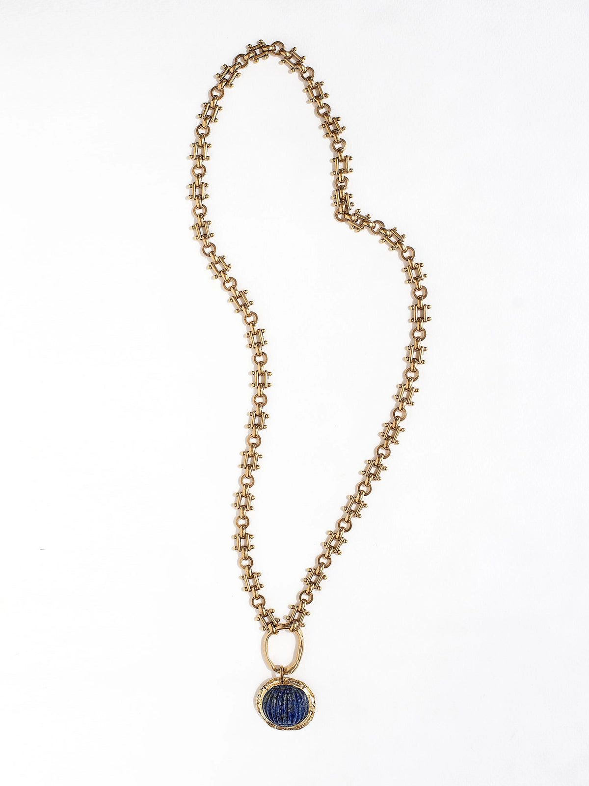 A brass watch chain necklace with lapis lazuli and brass pendant handcrafted by Canadian jewelry designer Michelle Ross