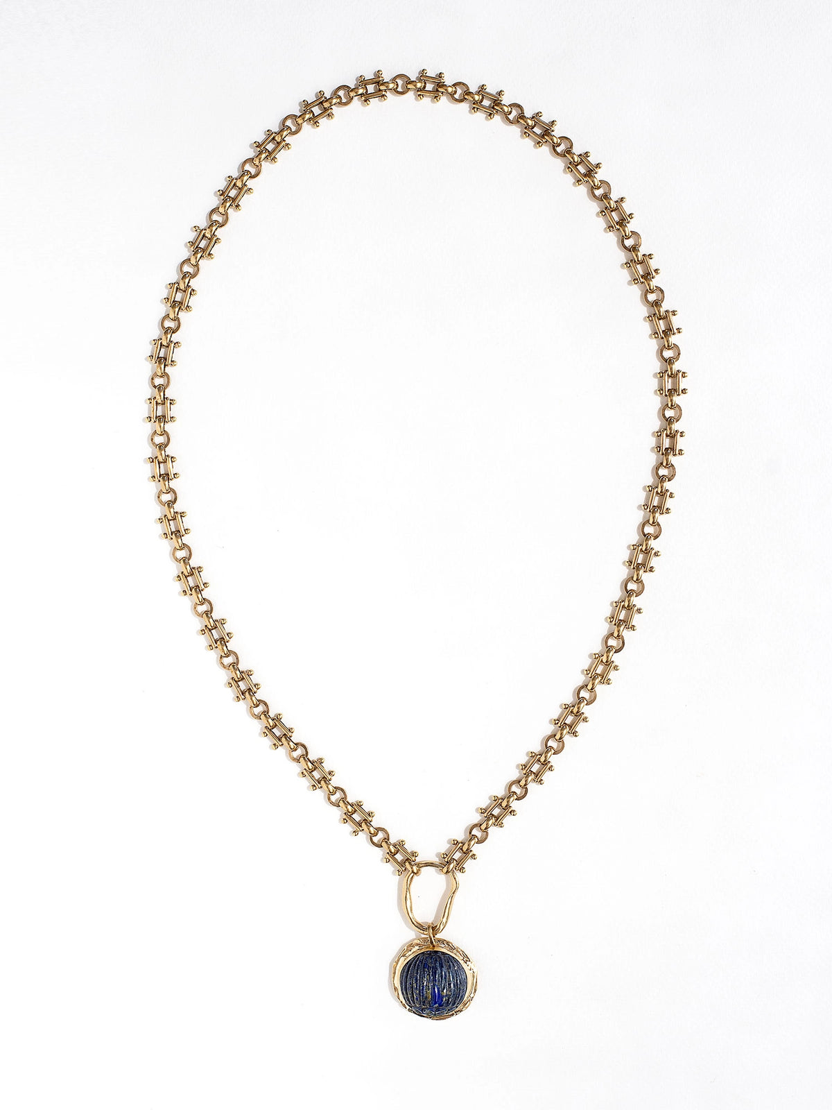 A brass watch chain necklace with lapis lazuli and brass pendant handcrafted by Canadian jewelry designer Michelle Ross