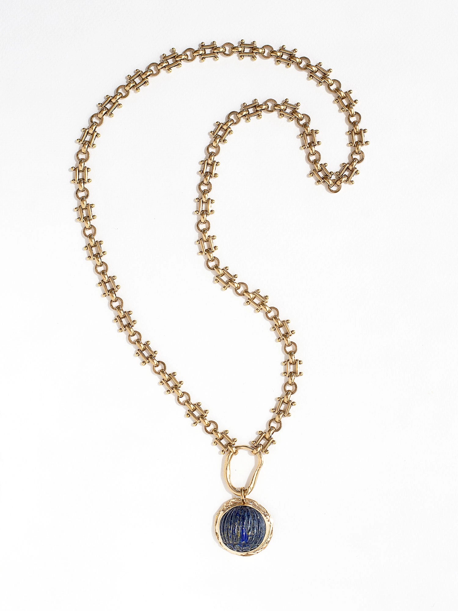 A brass watch chain necklace with lapis lazuli and brass pendant handcrafted by Canadian jewelry designer Michelle Ross