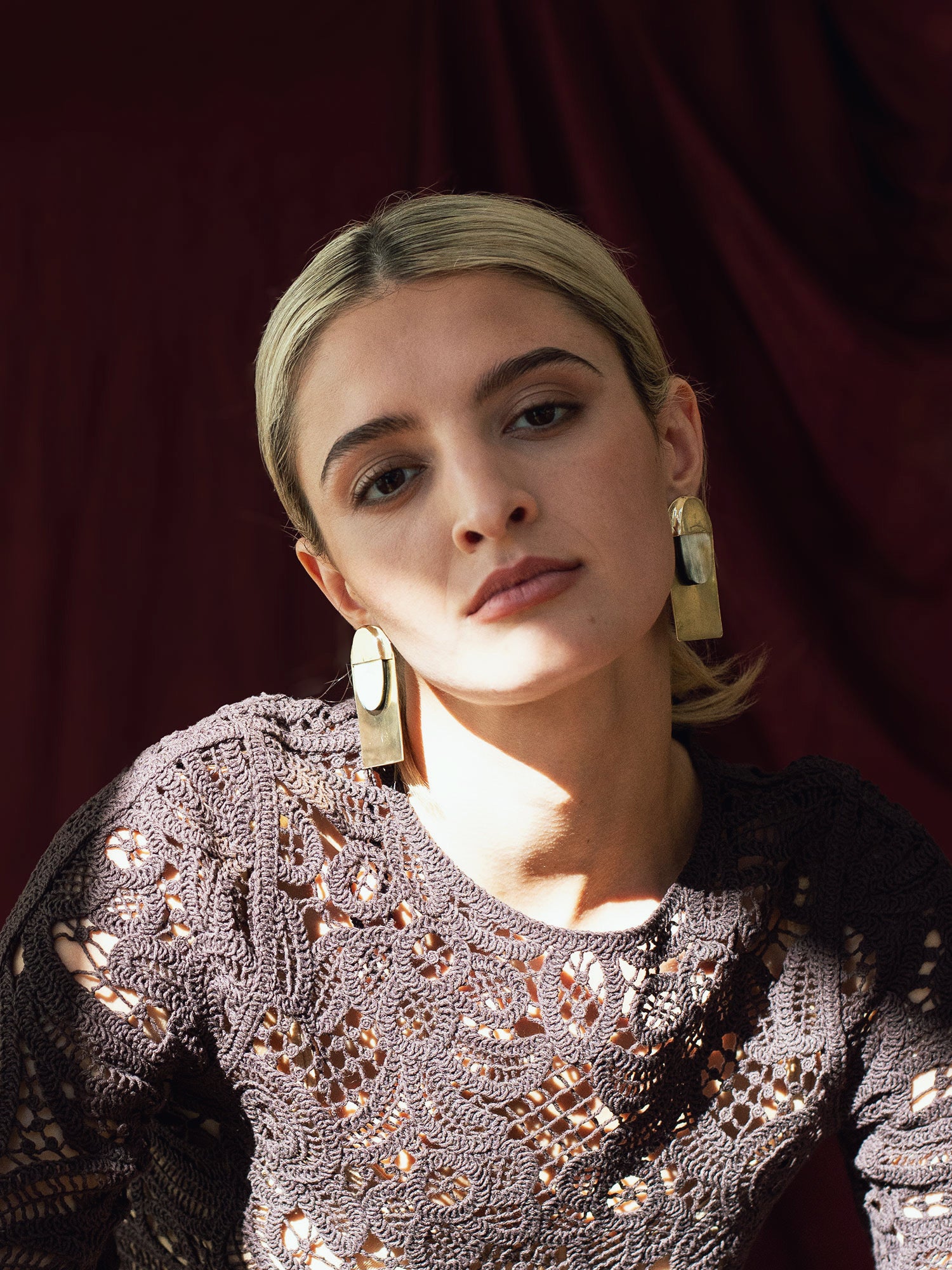 Pair of black horn and brass large statement stud earrings by Michelle Ross