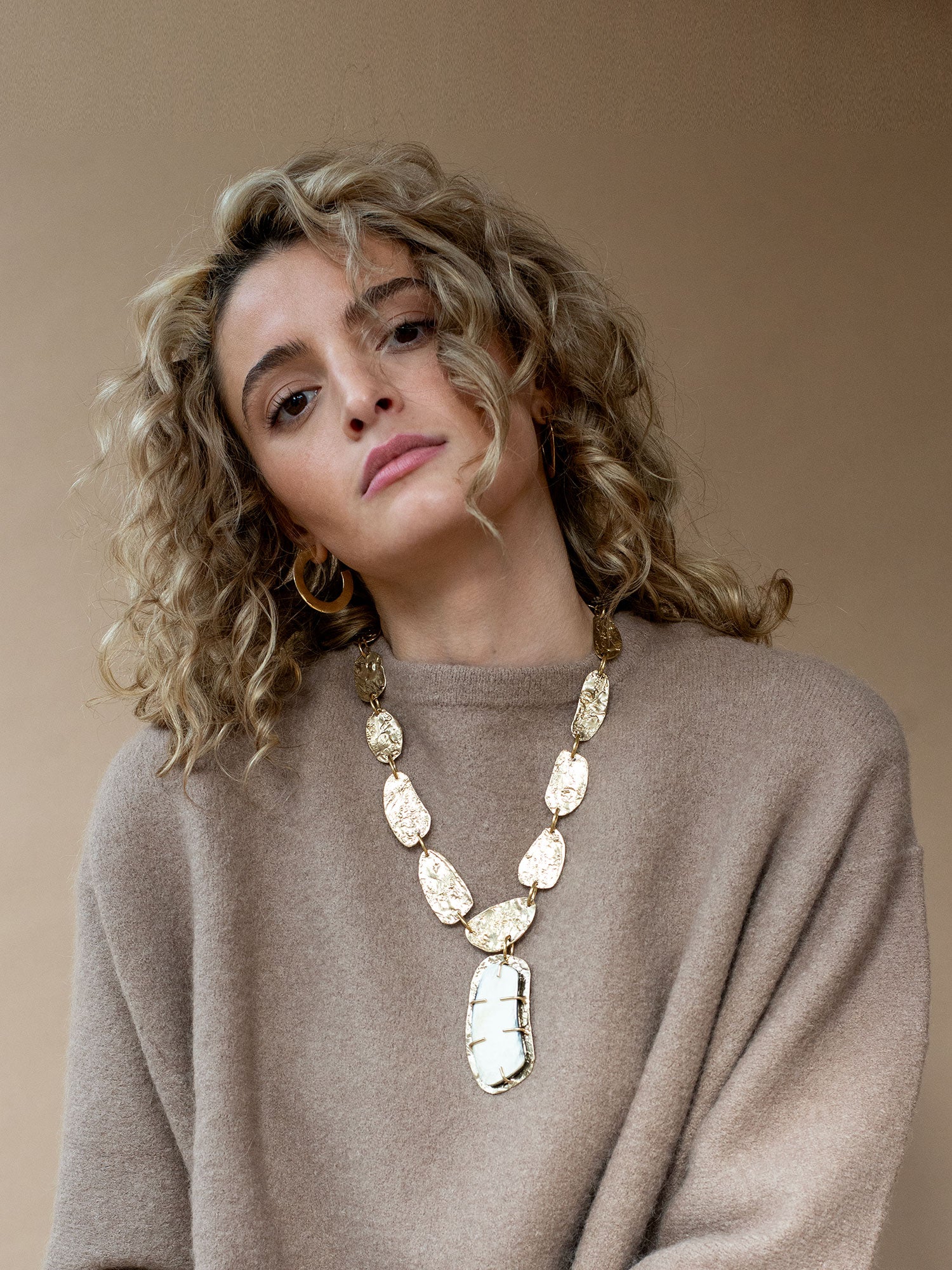 Brass Statement Necklace with large central horn pendant and brass hand formed discs by Michelle Ross