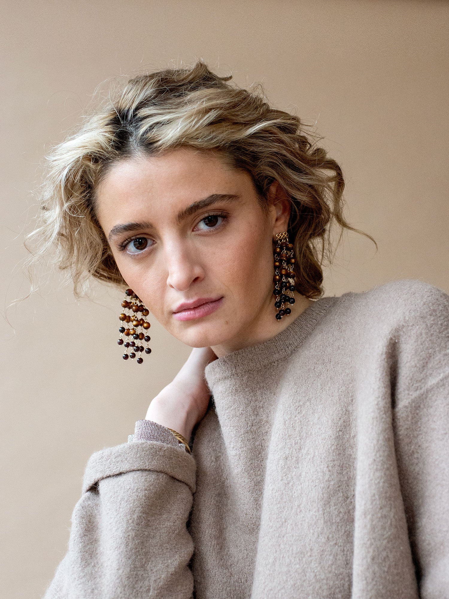 Pair of beaded dangly chandelier earrings made from sea bamboo and garnet beads by Michelle Ross