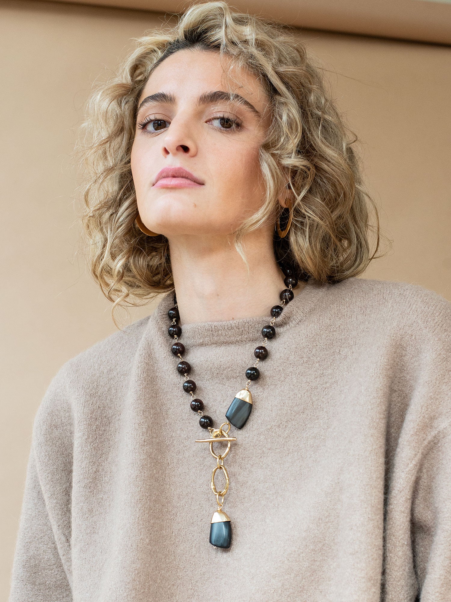 Lariat necklace with garnet beads and brass accents by Michelle Ross