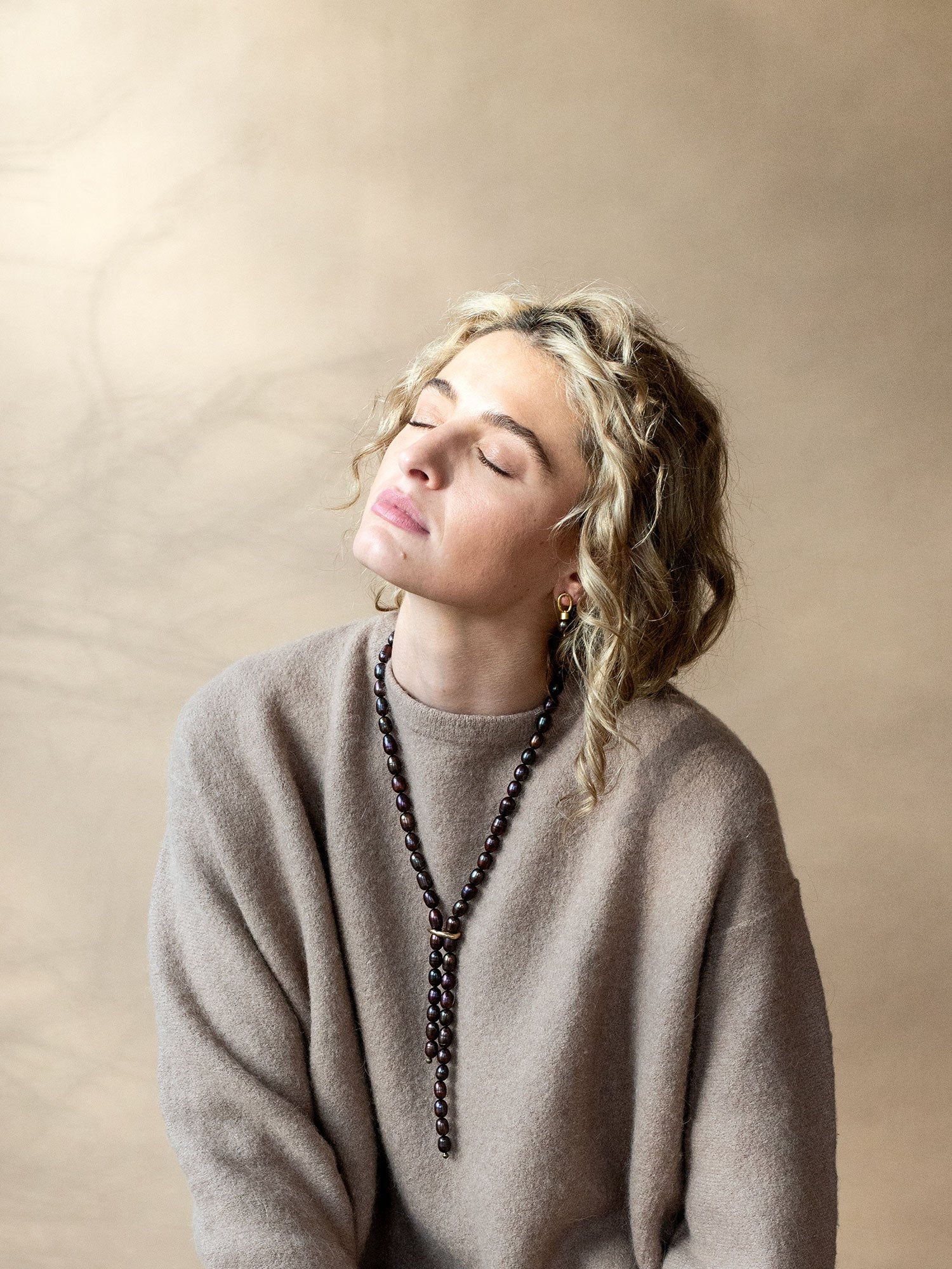 pair of brass earrings with espresso brown pearl drops