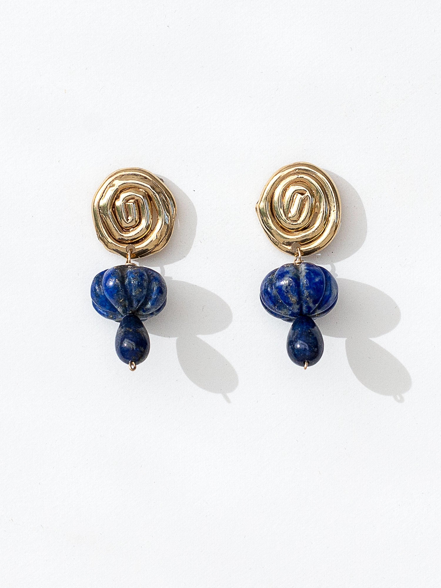 A pair of hand-formed brass spiral earrings with lapis lazuli beaded stone drop style by Canadian jewelry designer Michelle Ross