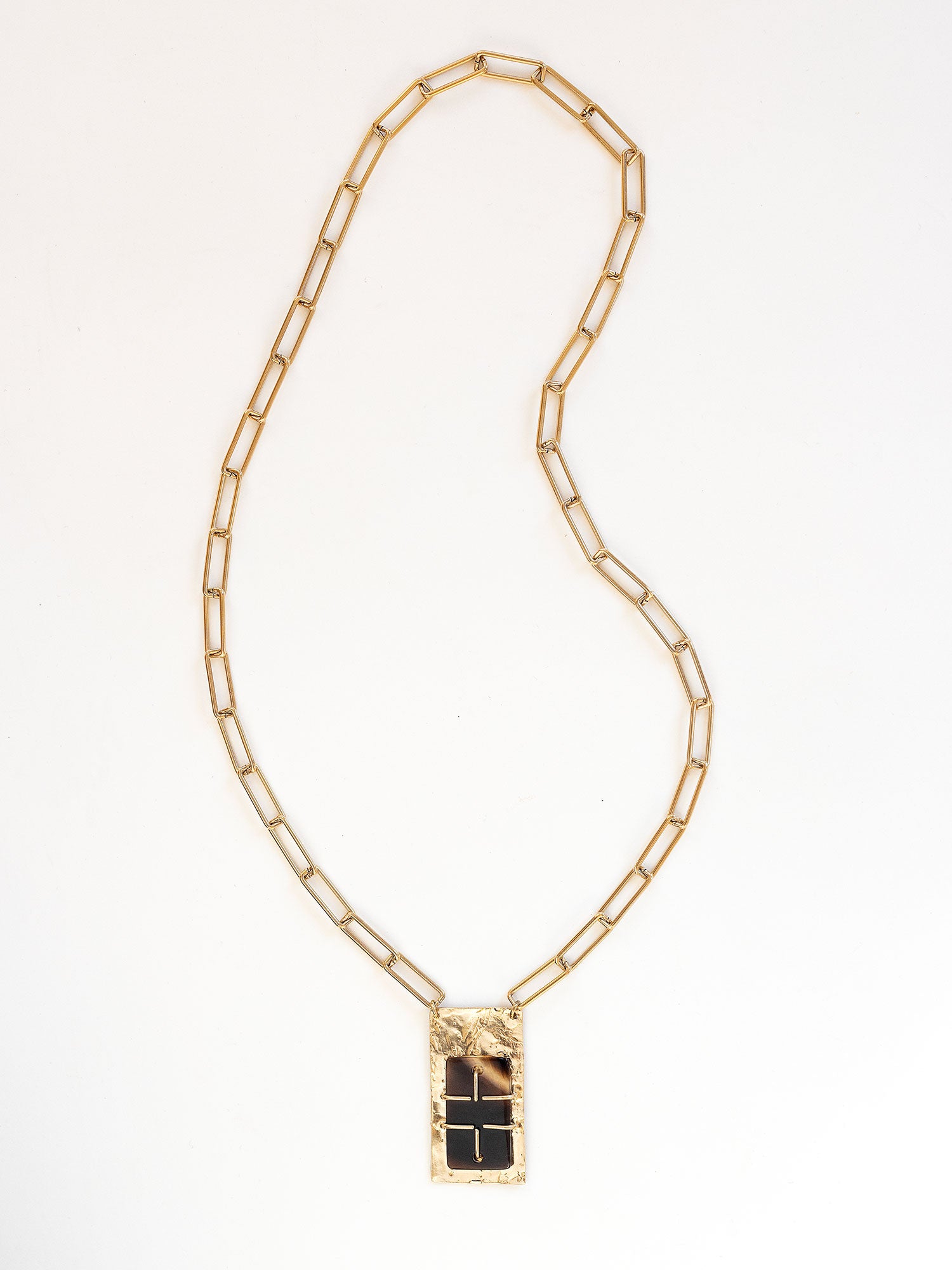 A brass rectangular chain link necklace with statement brass and horn rectangular pendant by Michelle Ross
