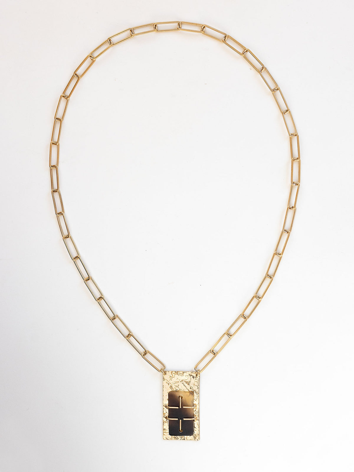 A brass rectangular chain link necklace with statement brass and horn rectangular pendant by Michelle Ross