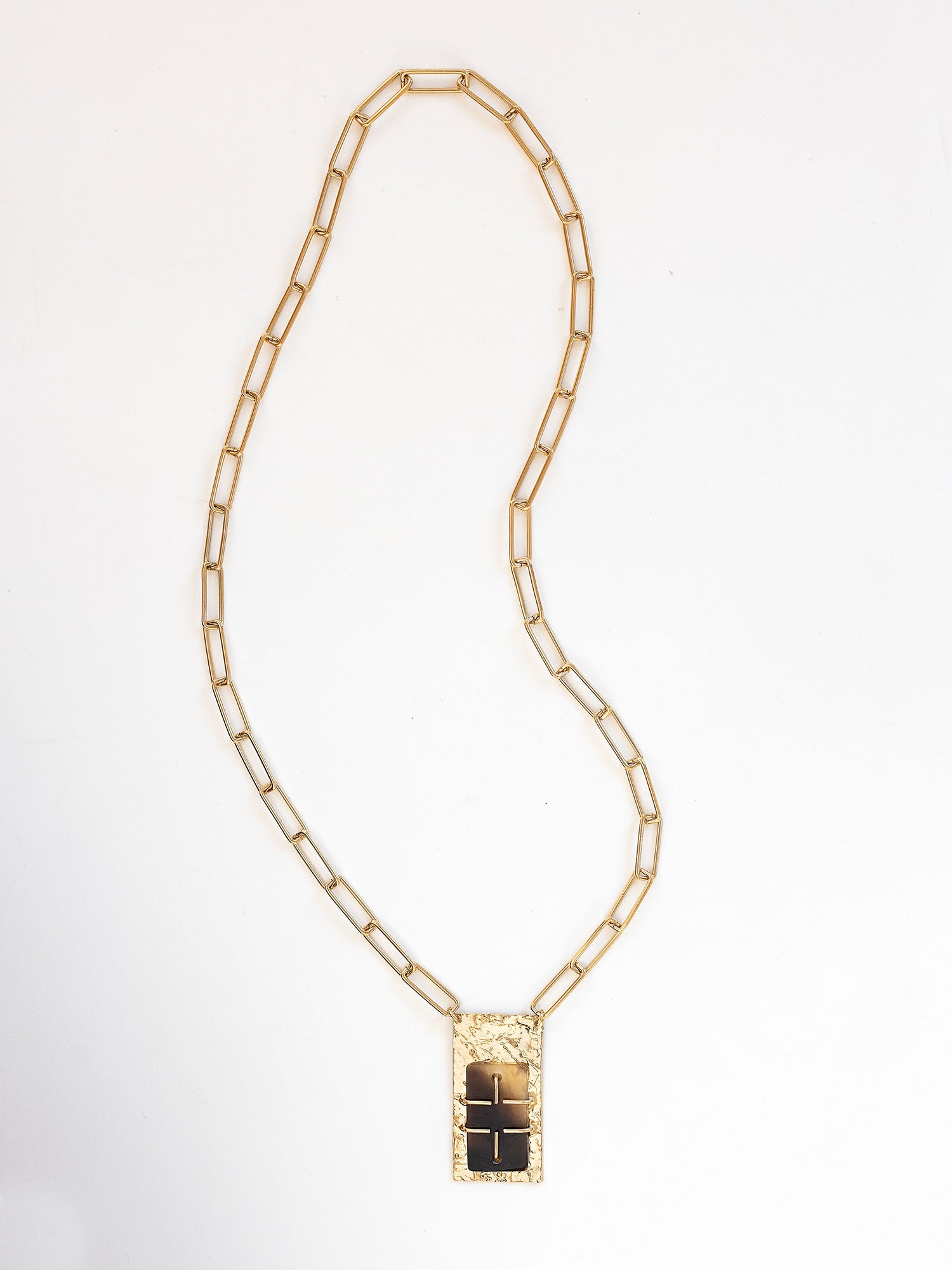 A brass rectangular chain link necklace with statement brass and horn rectangular pendant by Michelle Ross