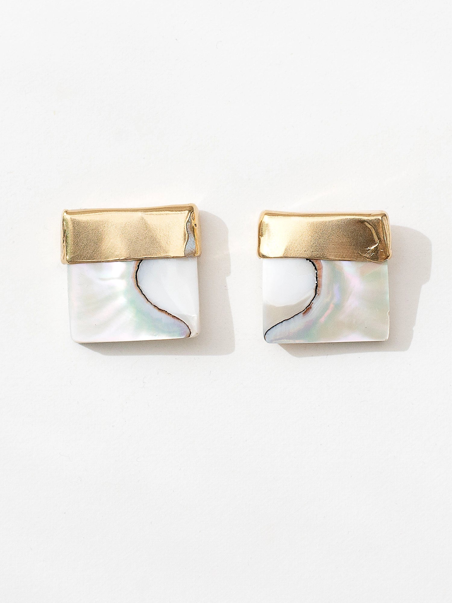 A pair of square shell mother of pearl and brass statement earrings by contemporary designer Michelle Ross