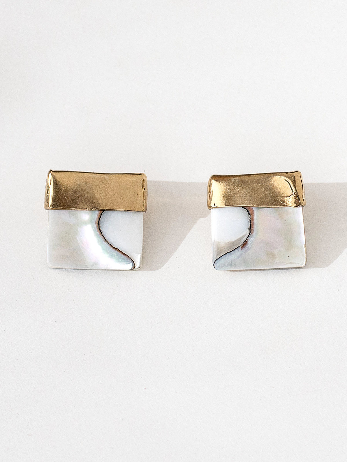 A pair of square shell mother of pearl and brass statement earrings by contemporary designer Michelle Ross