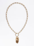 A brass chain necklace with a camel horn pendant by Michelle Ross