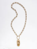 A brass chain necklace with a camel horn pendant by Michelle Ross