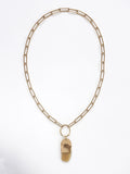 A brass chain necklace with a camel horn pendant by Michelle Ross