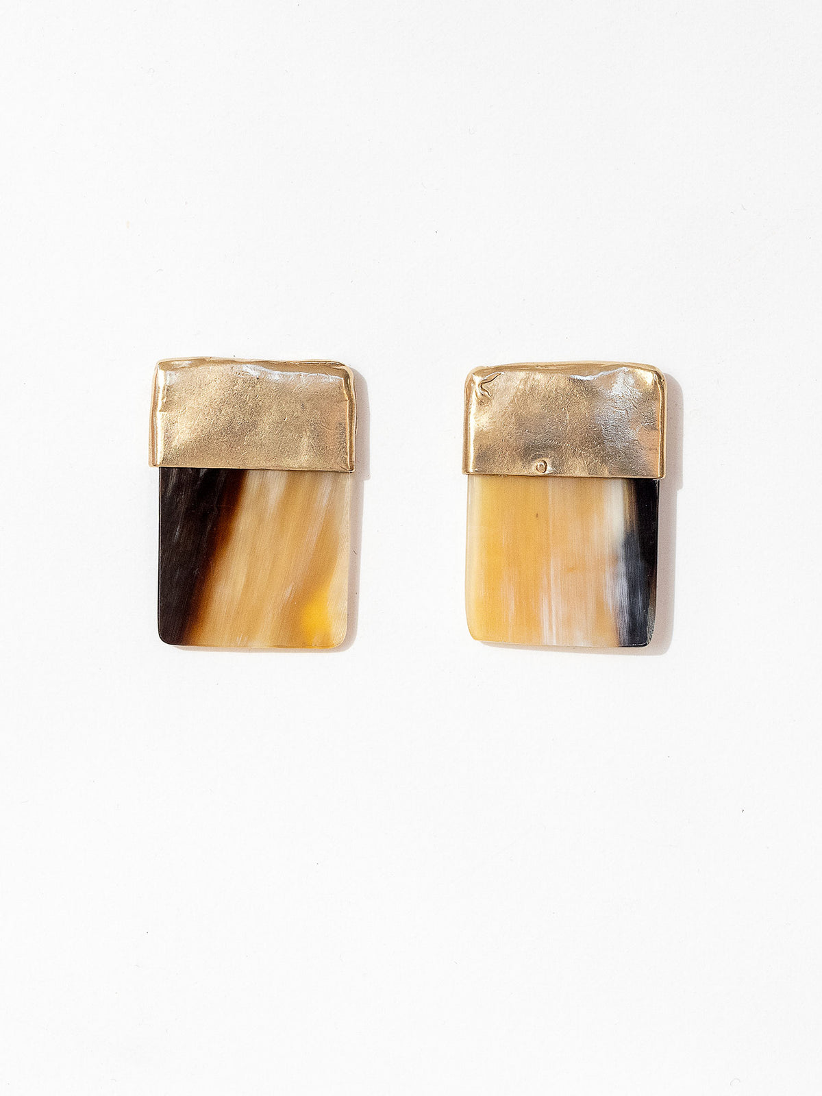 Pair of statement stud earrings with brass tops and brown horn bases in a square shape by Michelle Ross