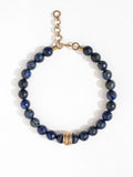 A lapis lazuli beaded choker necklace with brass scroll details by Canadian jewelry designer Michelle Ross