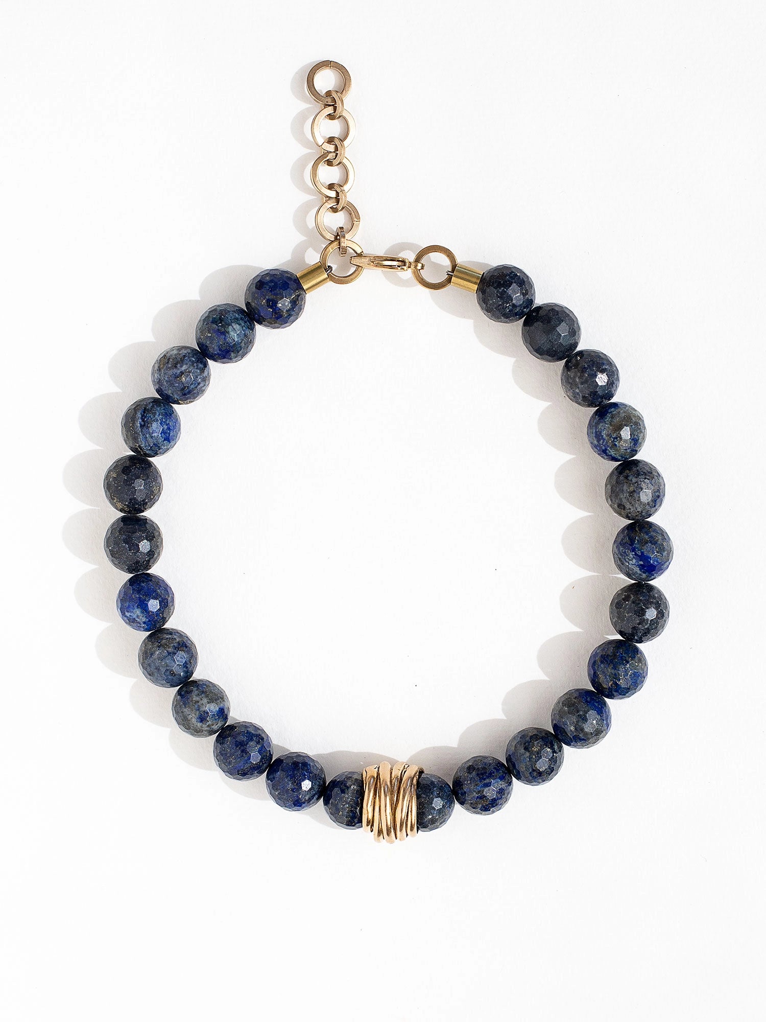 A lapis lazuli beaded choker necklace with brass scroll details by Canadian jewelry designer Michelle Ross