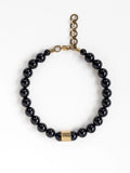A beaded necklace with black onyx beads and brass details by Michelle Ross