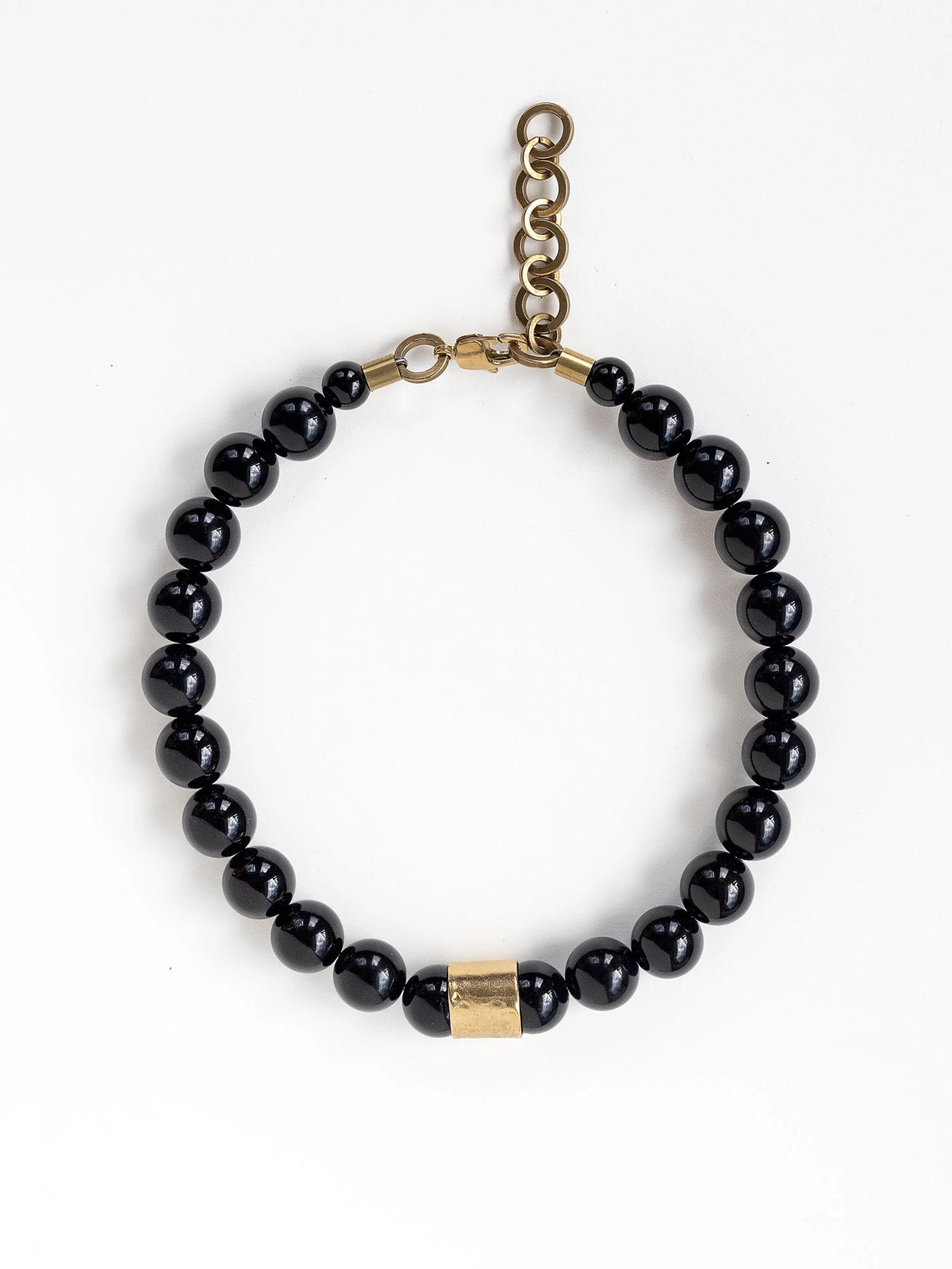 A beaded necklace with black onyx beads and brass details by Michelle Ross