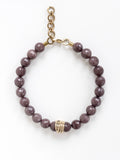 A beaded necklace with mauve purple aventurine beads and brass details by Michelle Ross