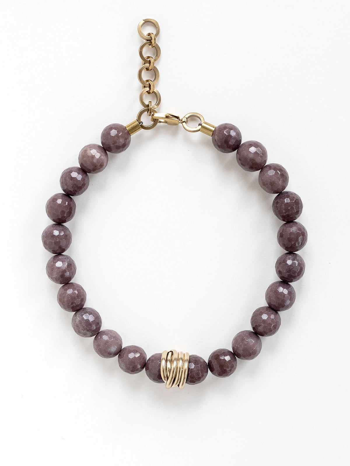 A beaded necklace with mauve purple aventurine beads and brass details by Michelle Ross