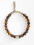 A beaded necklace with tiger eye beads and silver and brass details by Michelle Ross
