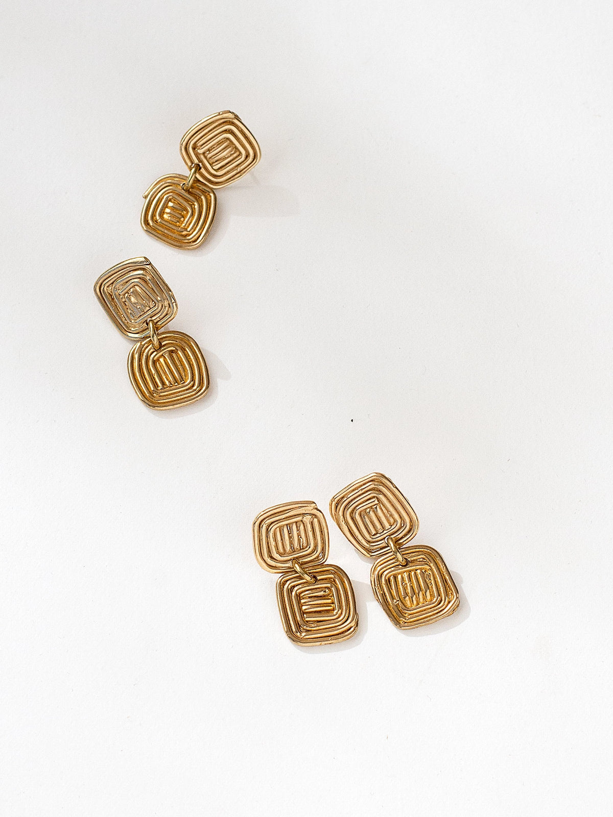 Two pairs of brass spiral drop earrings by contemporary designer Michelle Ross
