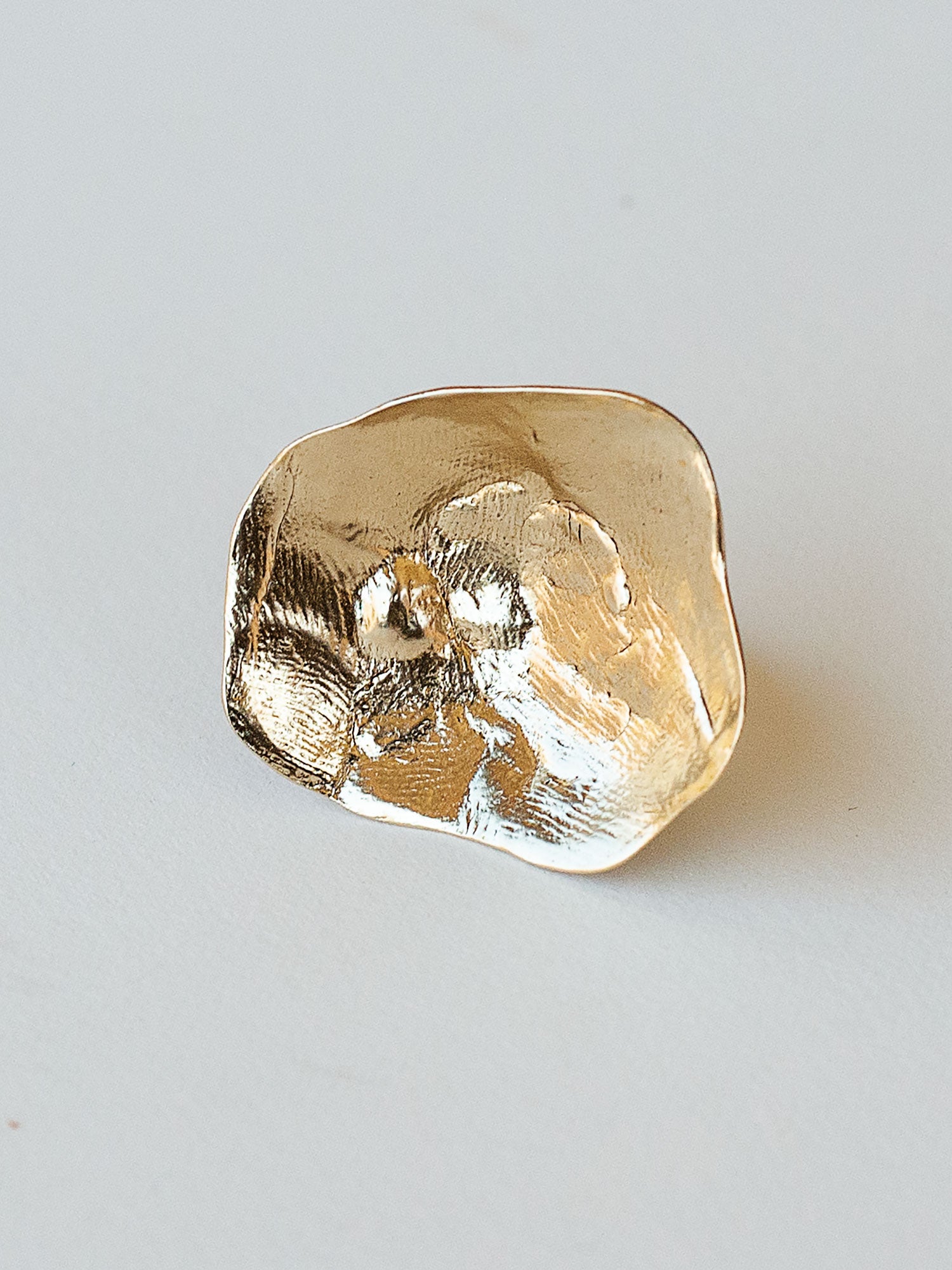 A sculptural statement ring in solid brass handmade by Michelle Ross in Toronto, Canada