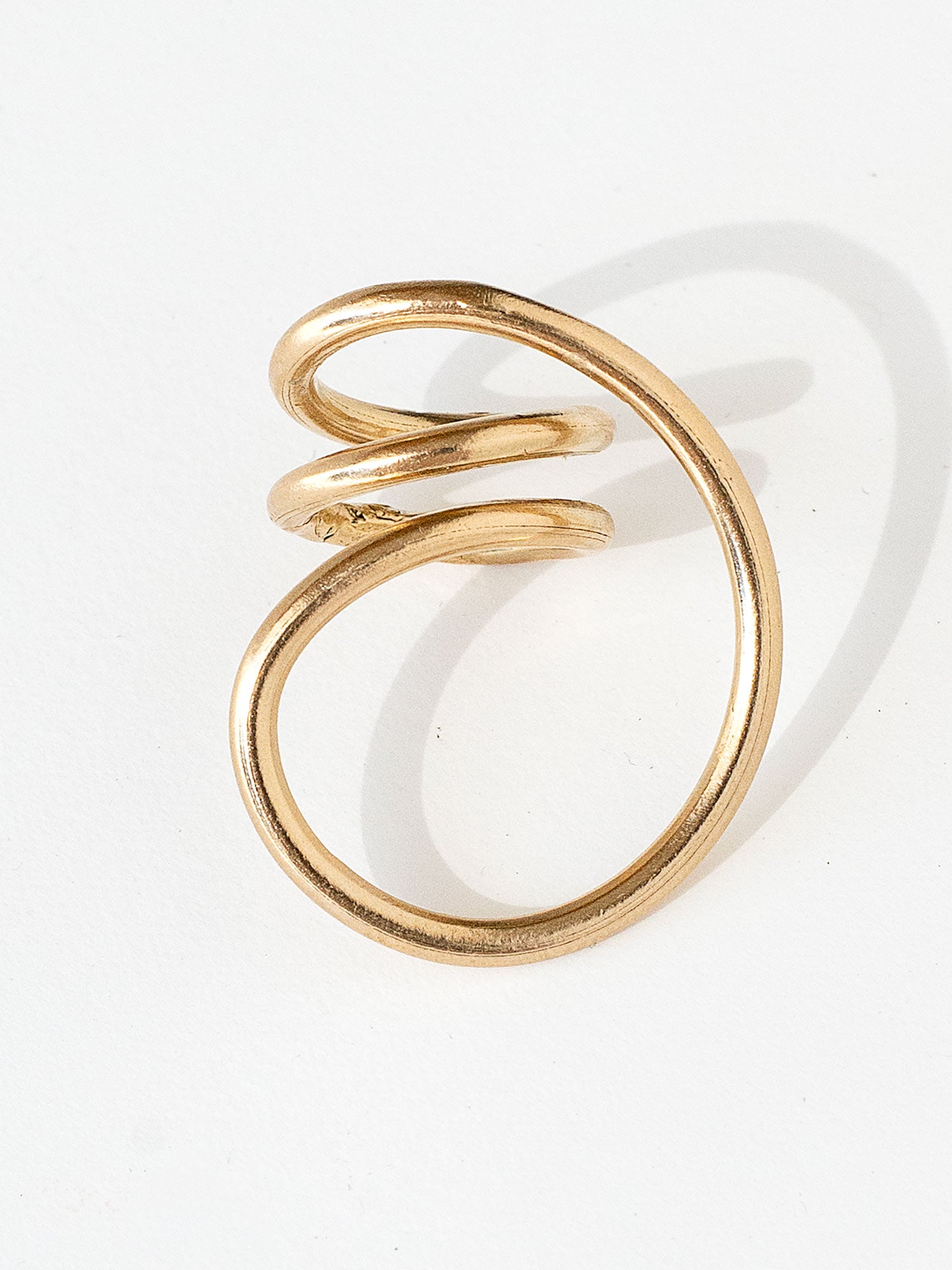 A handmade solid brass ring in an artistic twisting shape by Michele Ross in Toronto, Canada