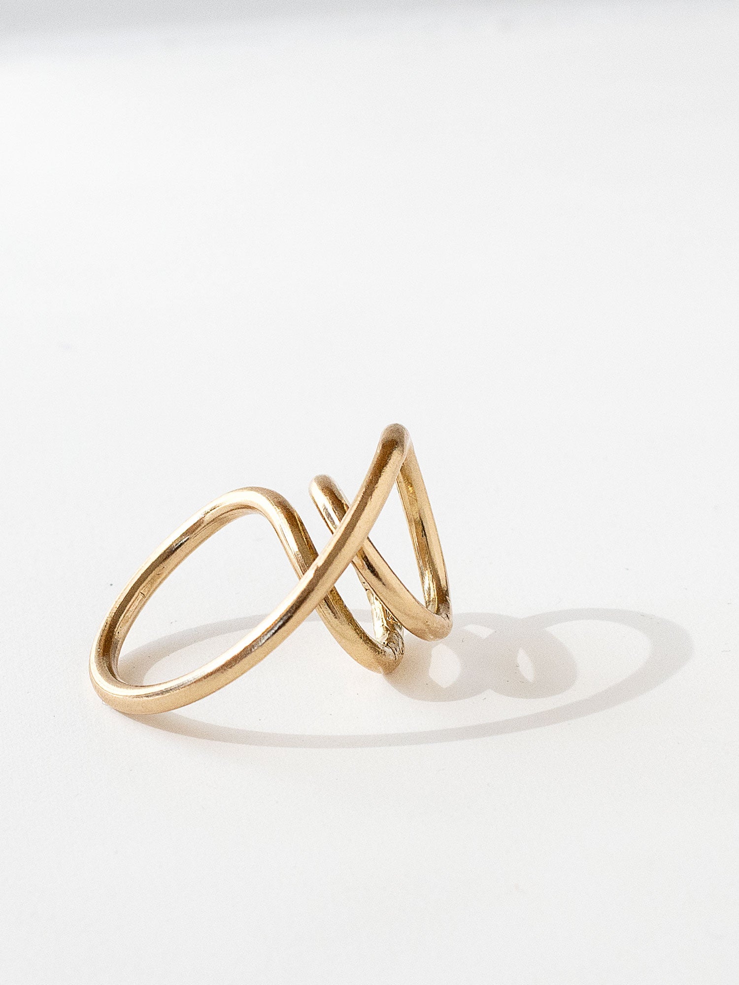 A handmade solid brass ring in an artistic twisting shape by Michele Ross in Toronto, Canada