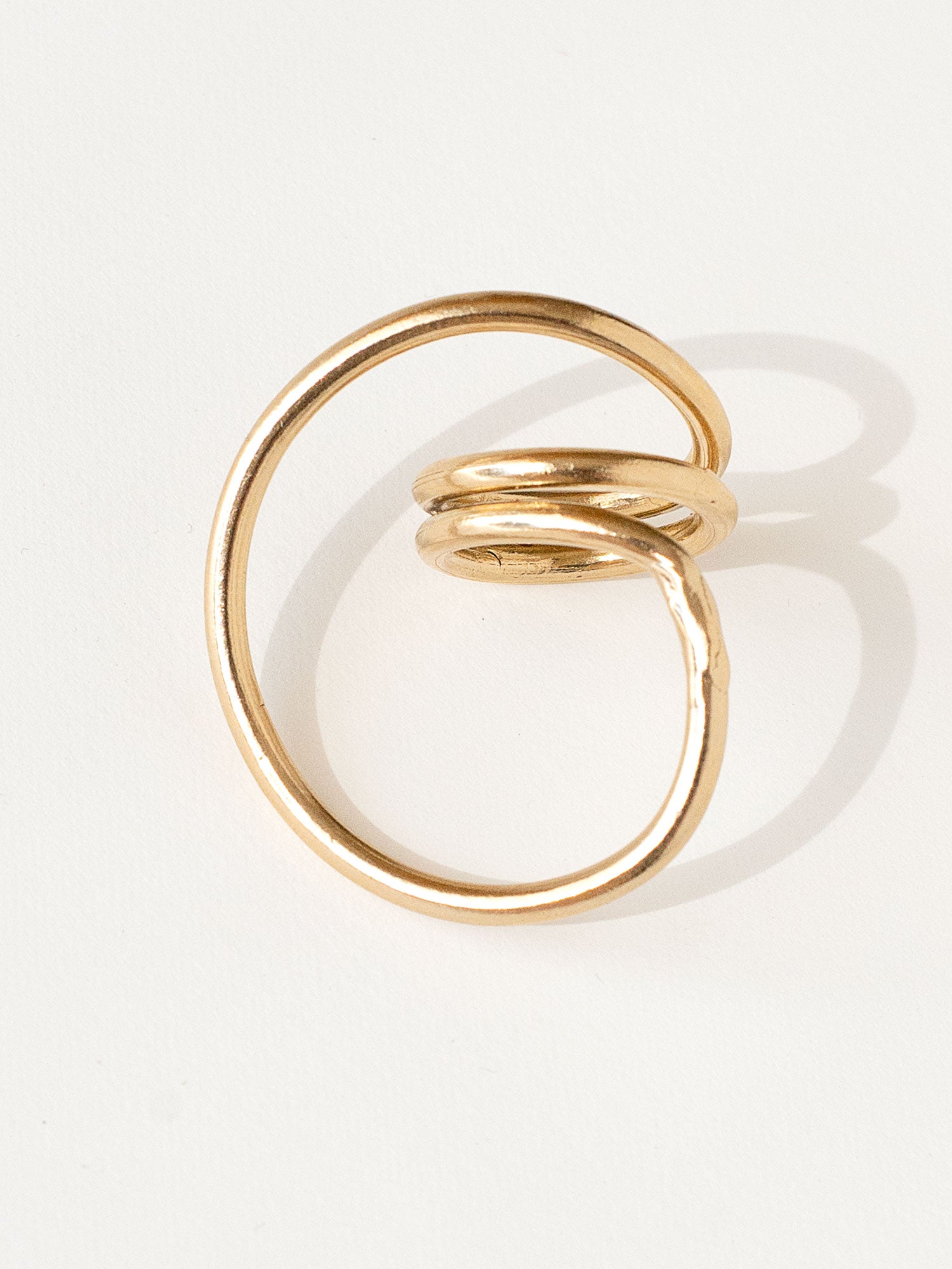 A handmade solid brass ring in an artistic twisting shape by Michele Ross in Toronto, Canada