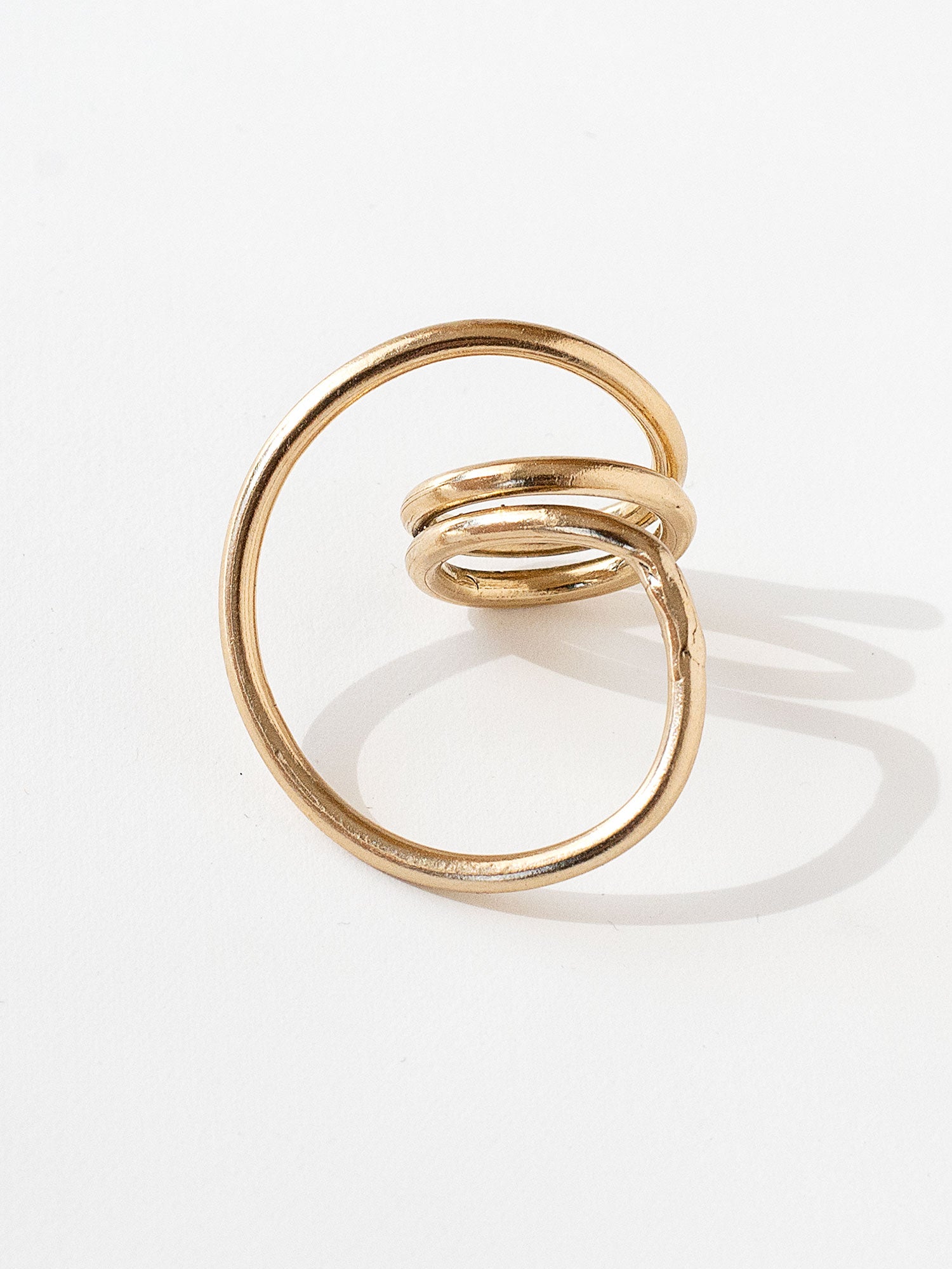 A handmade solid brass ring in an artistic twisting shape by Michele Ross in Toronto, Canada