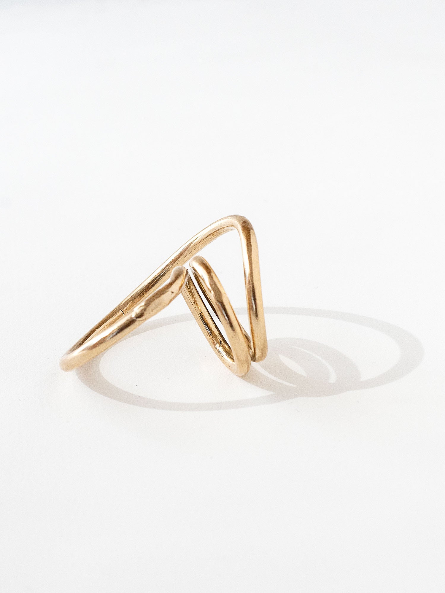 A handmade solid brass ring in an artistic twisting shape by Michele Ross in Toronto, Canada