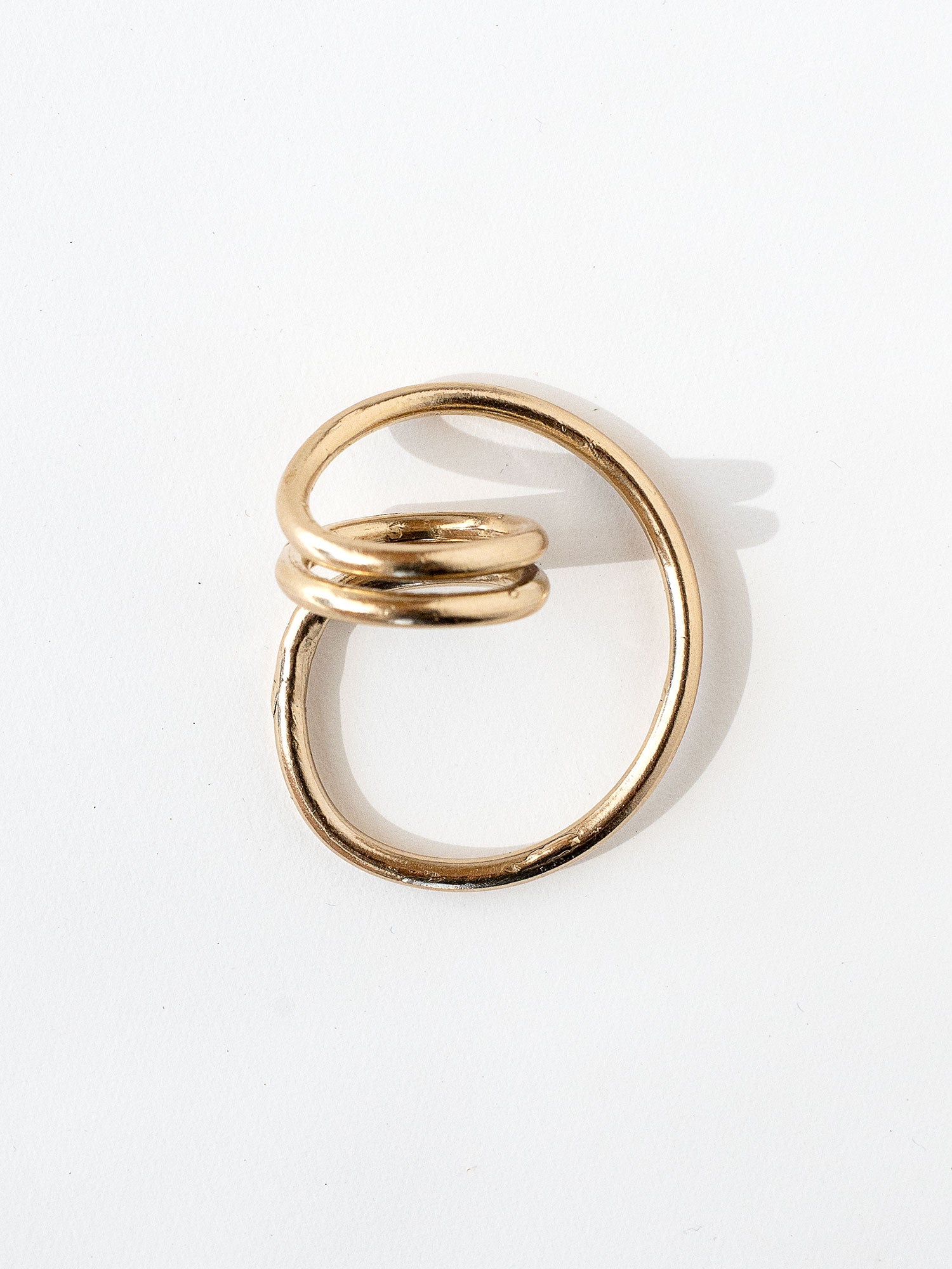 A handmade solid brass ring in an artistic twisting shape by Michele Ross in Toronto, Canada