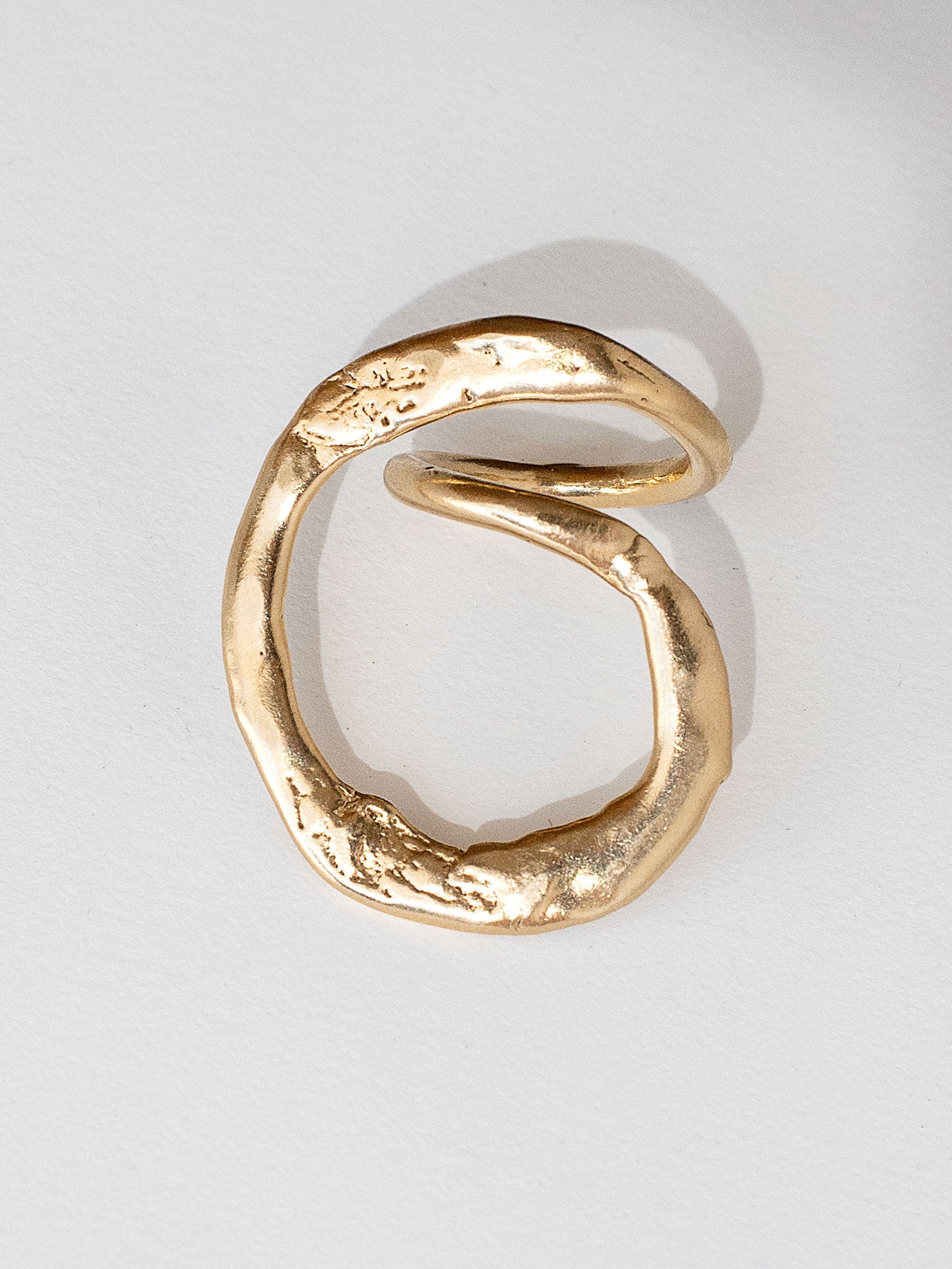 A handmade solid brass ring in an artistic twisting shape by Michele Ross in Toronto, Canada