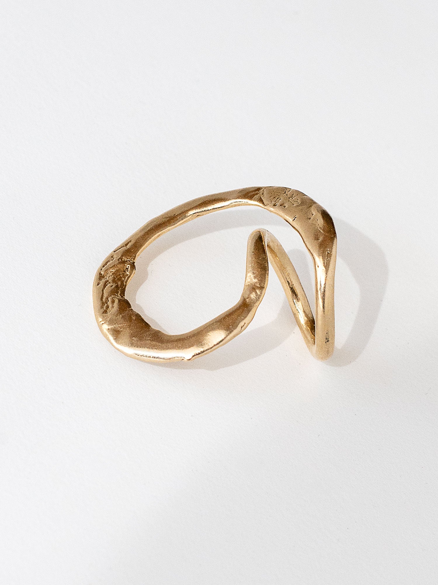A handmade solid brass ring in an artistic twisting shape by Michele Ross in Toronto, Canada