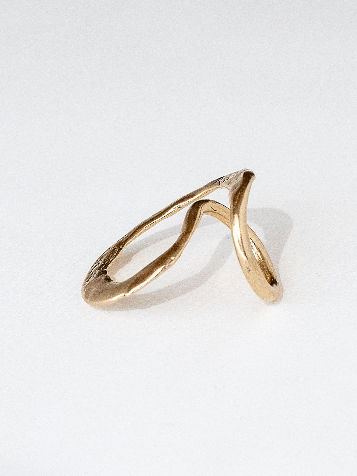 A handmade solid brass ring in an artistic twisting shape by Michele Ross in Toronto, Canada