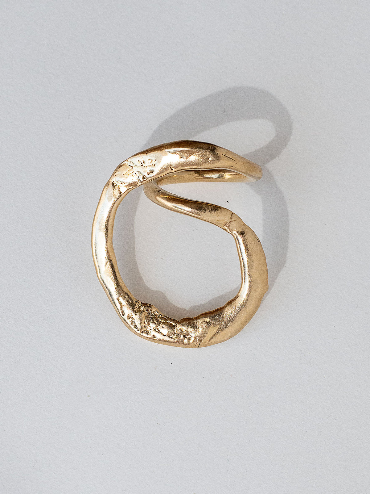 A handmade solid brass ring in an artistic twisting shape by Michele Ross in Toronto, Canada