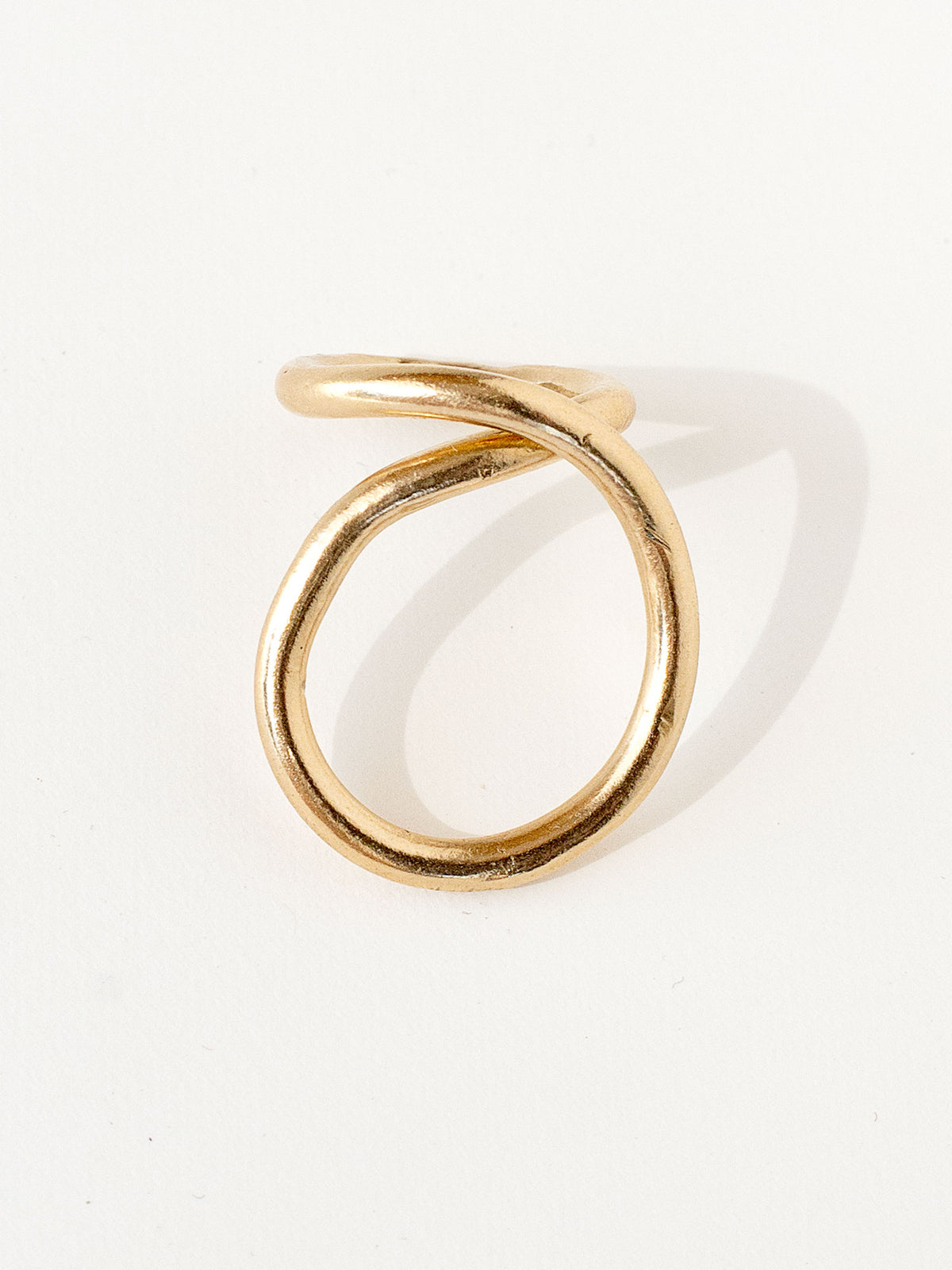 A handmade solid brass ring in an artistic twisting shape by Michele Ross in Toronto, Canada