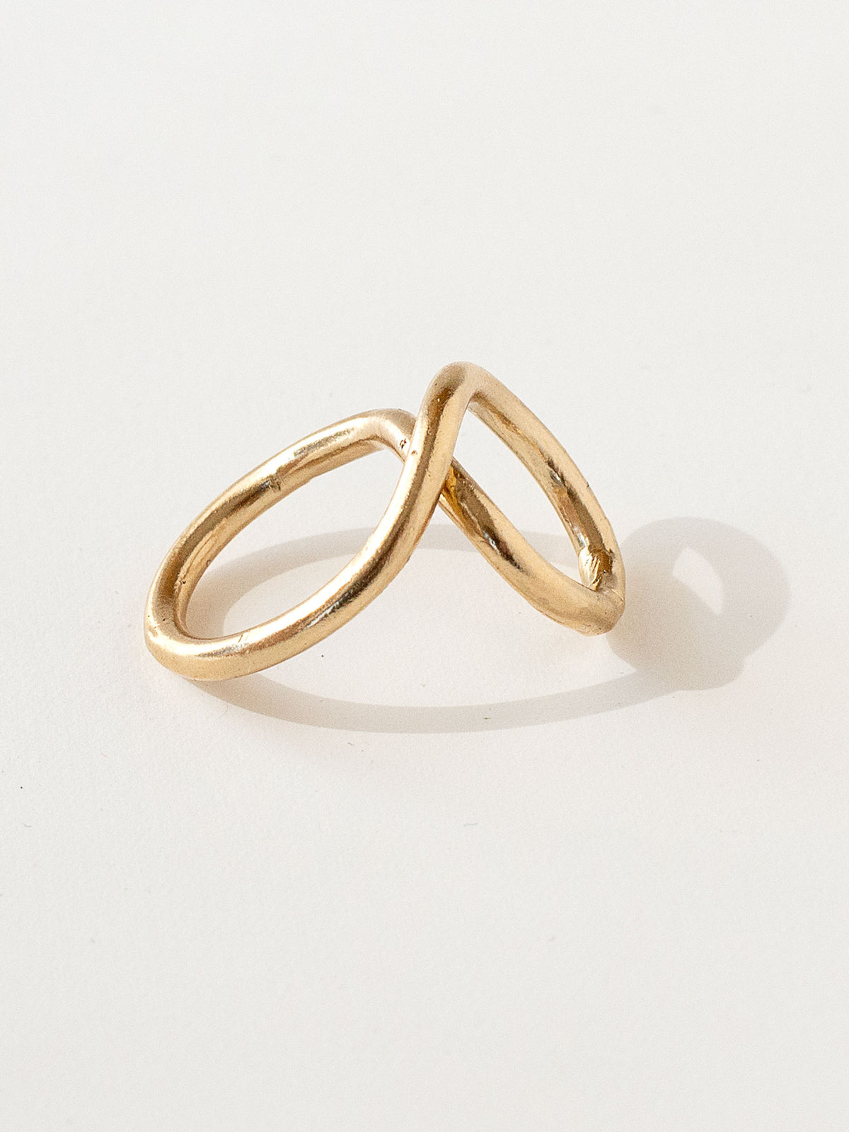 A handmade solid brass ring in an artistic twisting shape by Michele Ross in Toronto, Canada