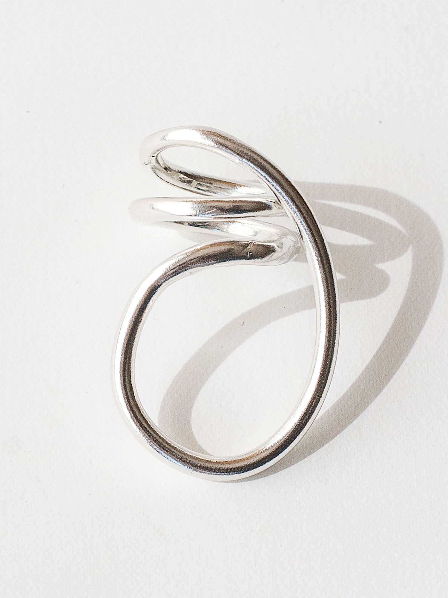 A handmade solid sterling silver ring in an artistic twisting shape by Michele Ross in Toronto, Canada
