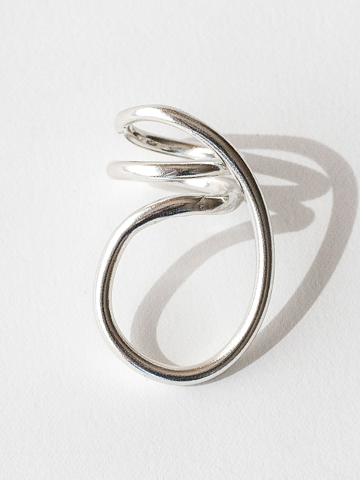 A handmade solid sterling silver ring in an artistic twisting shape by Michele Ross in Toronto, Canada