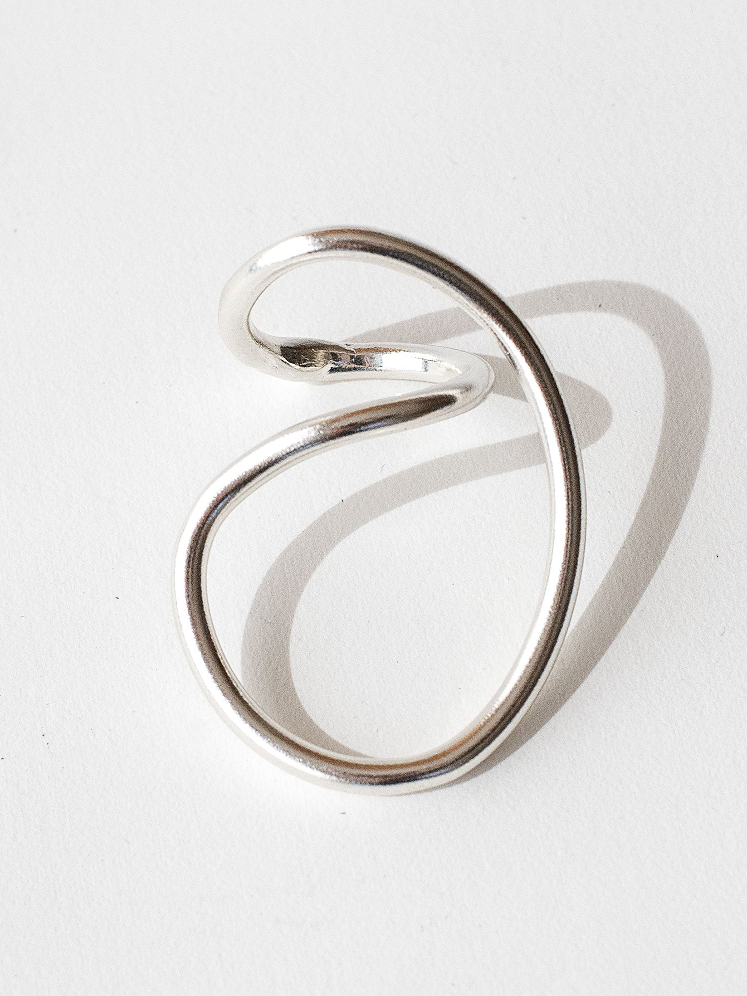 A handmade solid sterling silver ring in an artistic twisting shape by Michele Ross in Toronto, Canada